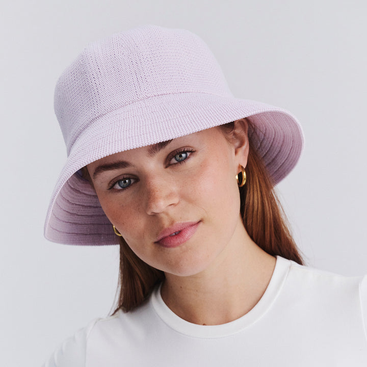 Female model wearing Tamzin Bucket Hat in Lilac colour, three-quarter angle highlighting shape and silhouette