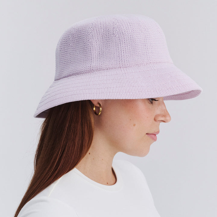 Female model wearing Tamzin Bucket Hat in Lilac colour, side profile showing brim coverage