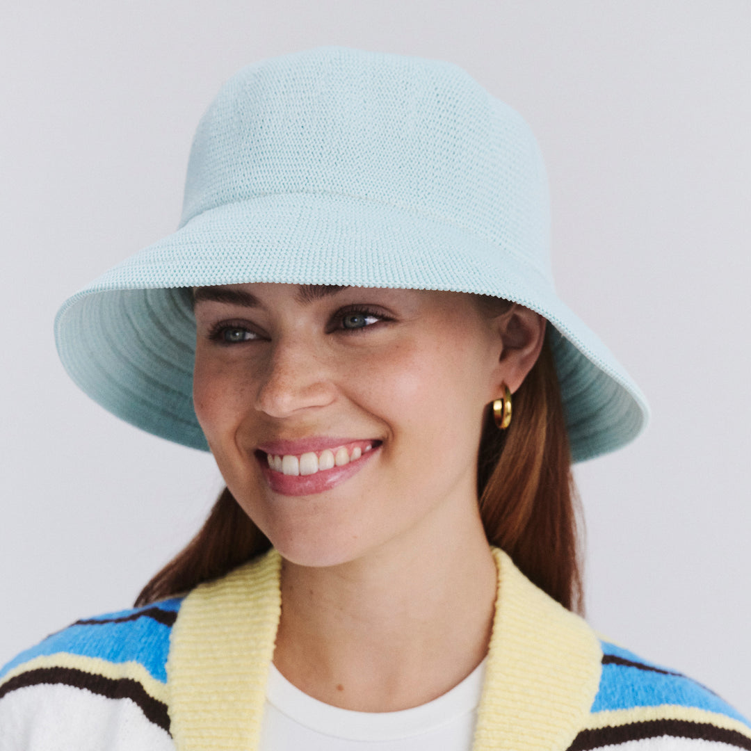 Female model wearing Tamzin Bucket Hat in Mint Blue colour, three-quarter angle highlighting shape and silhouette