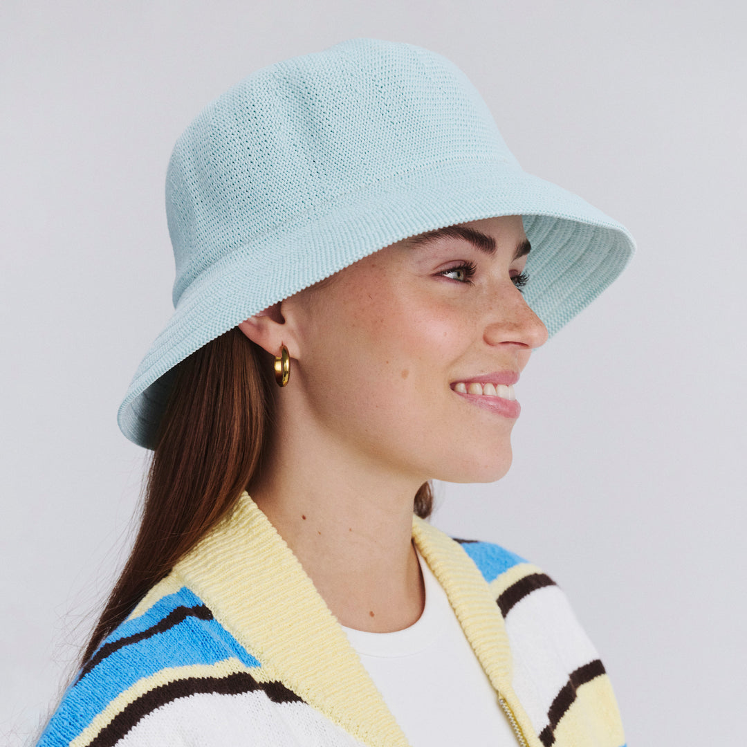 Female model wearing Tamzin Bucket Hat in Mint Blue colour, side profile showing brim coverage