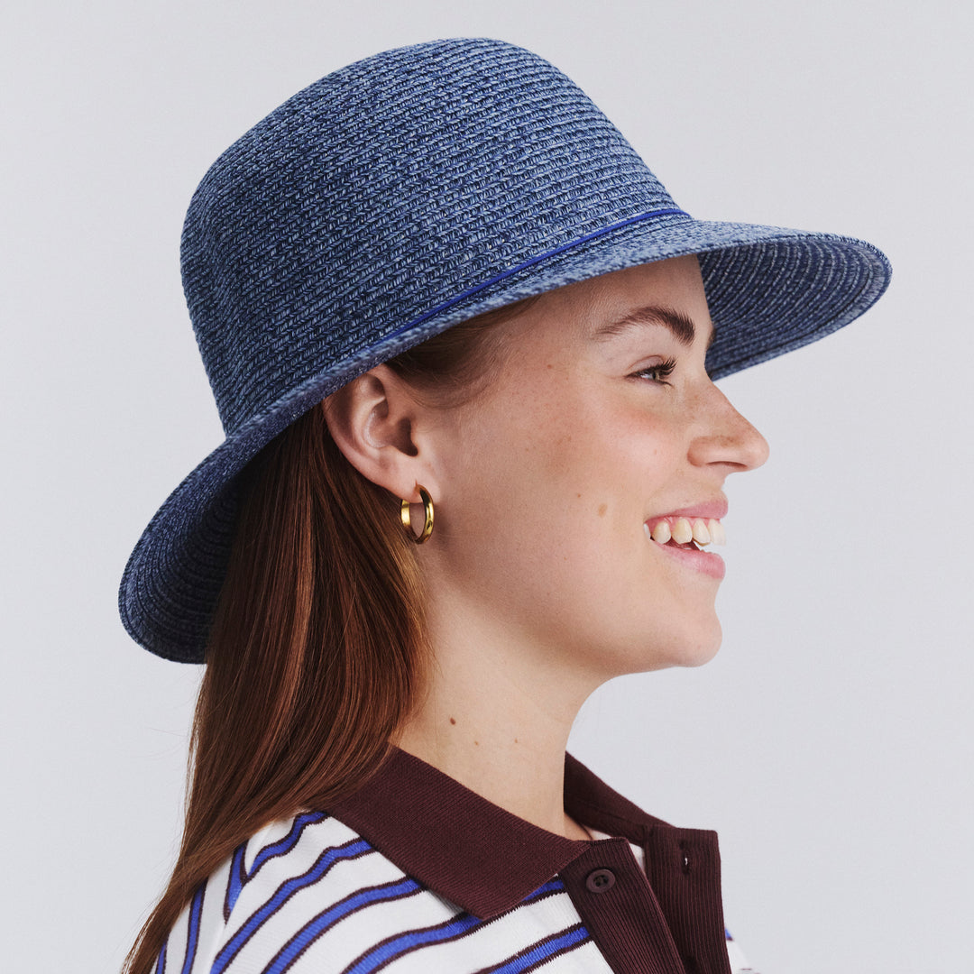 Side profile of female model wearing Lacey bucket hat in Denim