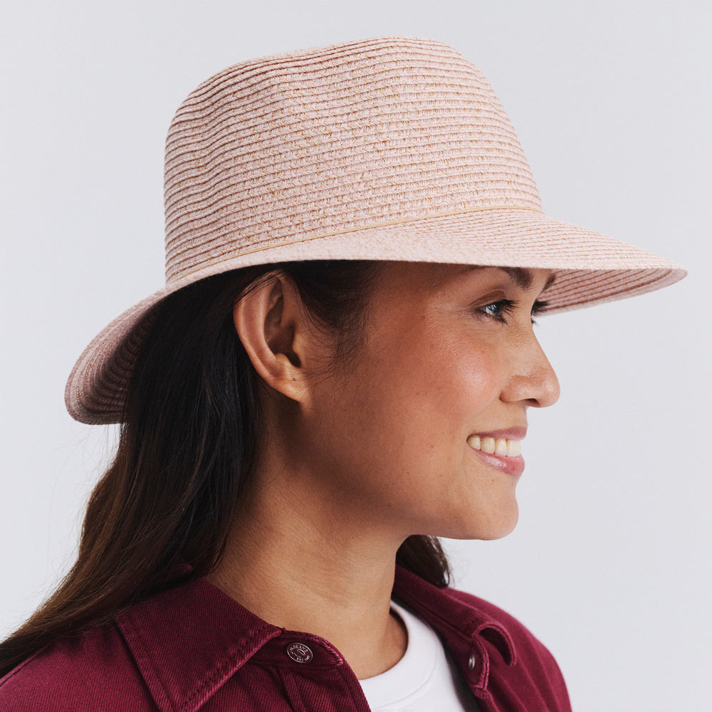 Side profile of female model wearing Lacey bucket hat in Soft Pink