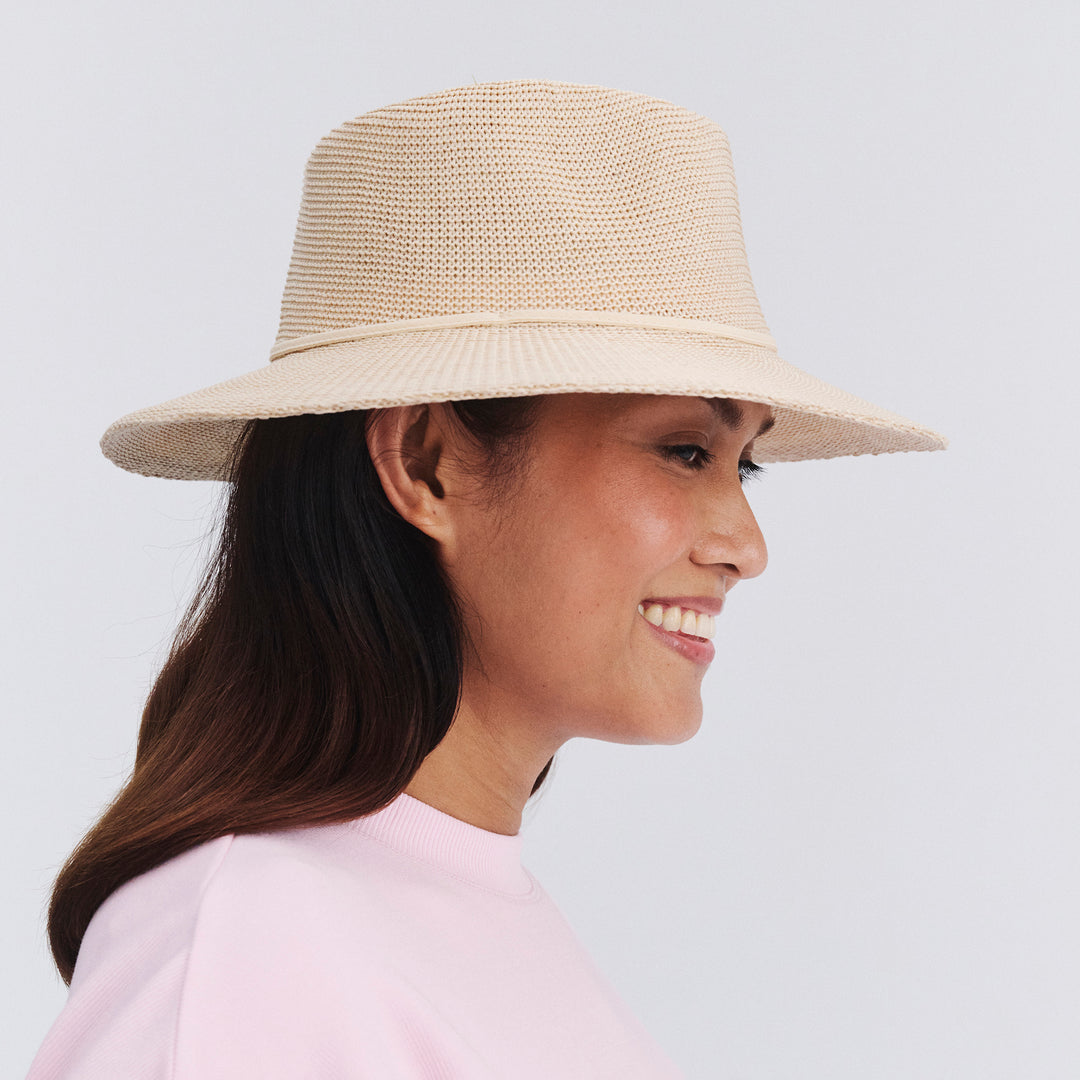 Side profile of female model wearing Jacqui mannish hat in Beige