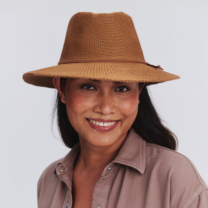 Female model wearing Jacqui Mannish Hat in biscuit colour, front view styled with modern outfit