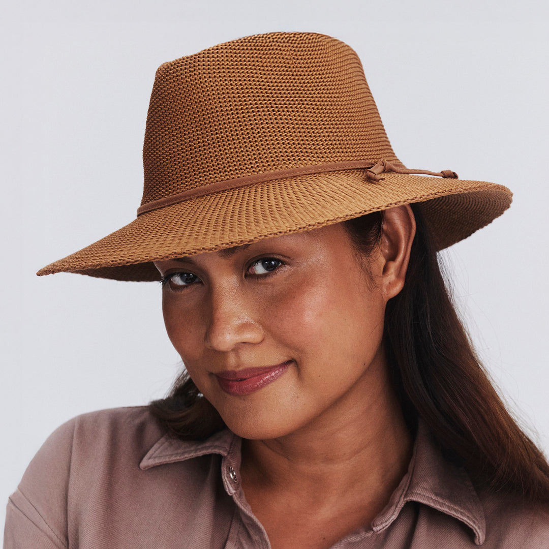 Female model wearing Jacqui Mannish Hat in biscuit colour, three-quarter angle highlighting fit and silhouette