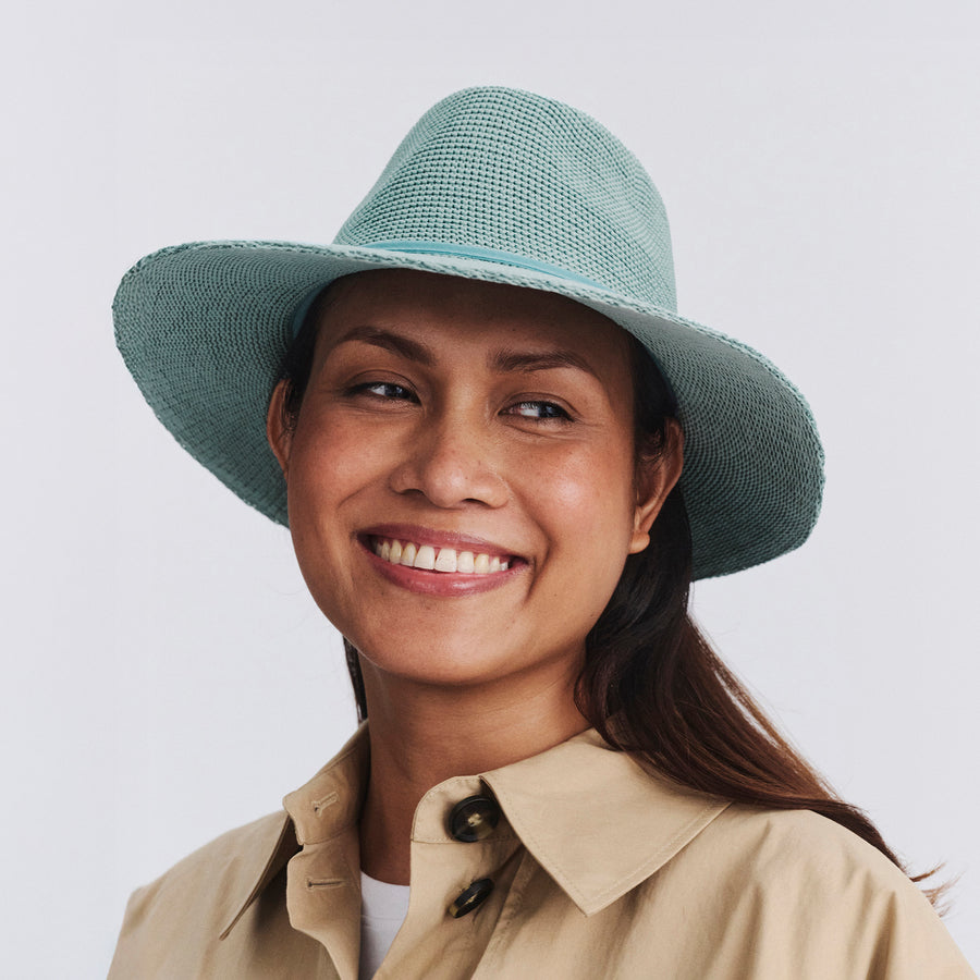 Female model wearing Jacqui Mannish Hat in blue haze colour, front view styled with neutral outfit