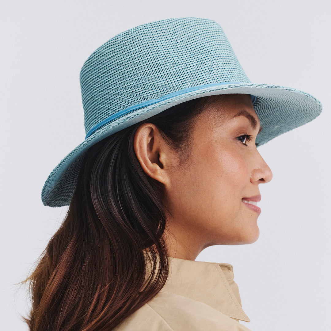 Female model wearing Jacqui Mannish Hat in blue haze colour, opposite side profile showing structured shape and brim detail