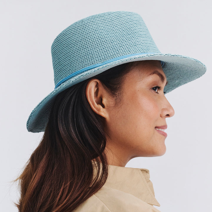 Female model wearing Jacqui Mannish Hat in blue haze colour, opposite side profile showing structured shape and brim detail