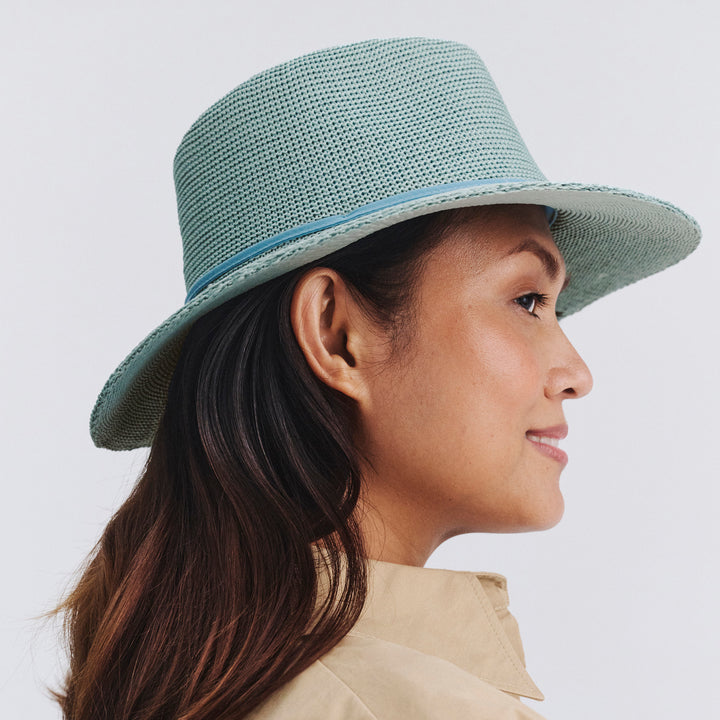 Female model wearing Jacqui Mannish Hat in blue haze colour, opposite side profile showing structured shape and brim detail