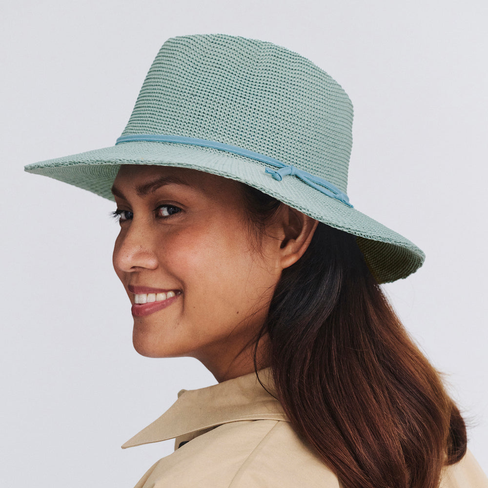 Female model wearing Jacqui Mannish Hat in blue haze colour, side profile showing structured shape and brim detail