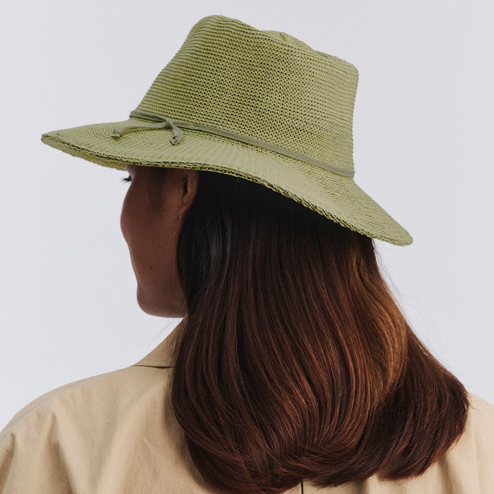 Female model wearing Jacqui Mannish Hat in light moss green colour, back view showing fit and rear crown shape