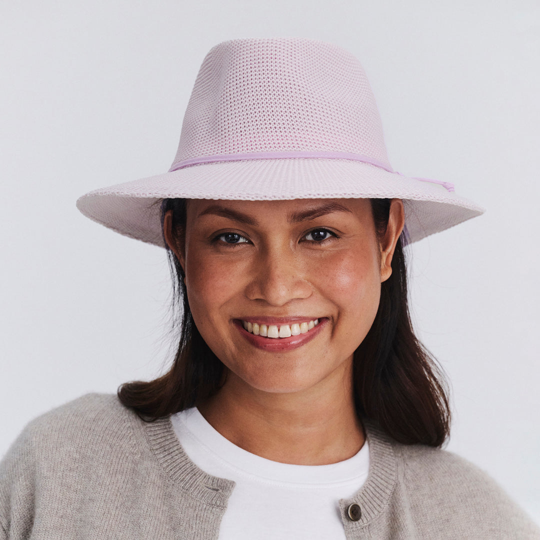 Female model wearing Jacqui Mannish Hat in Lilac colour, front view showcasing fit and wide brim