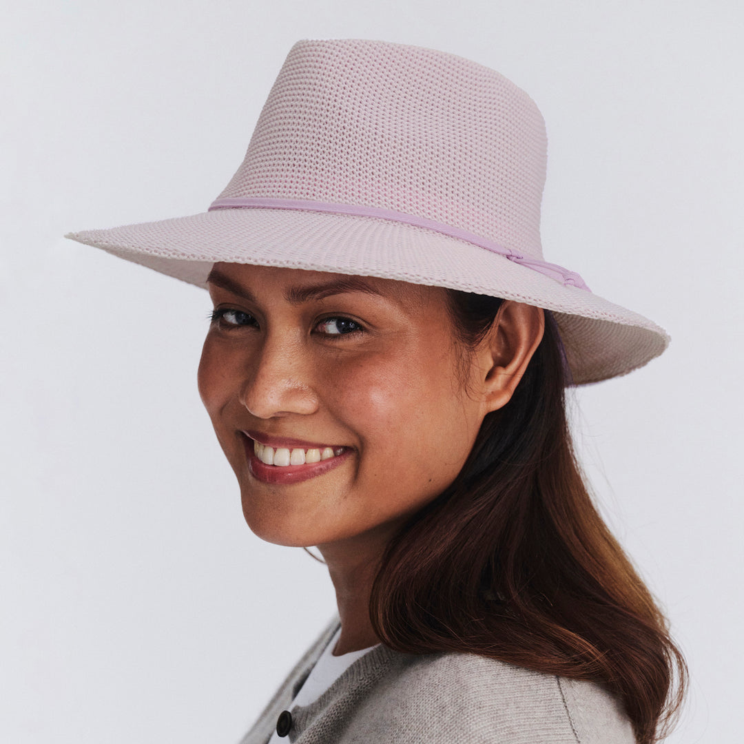 Female model wearing Jacqui Mannish Hat in Lilac colour, three-quarter angle highlighting shape and silhouette