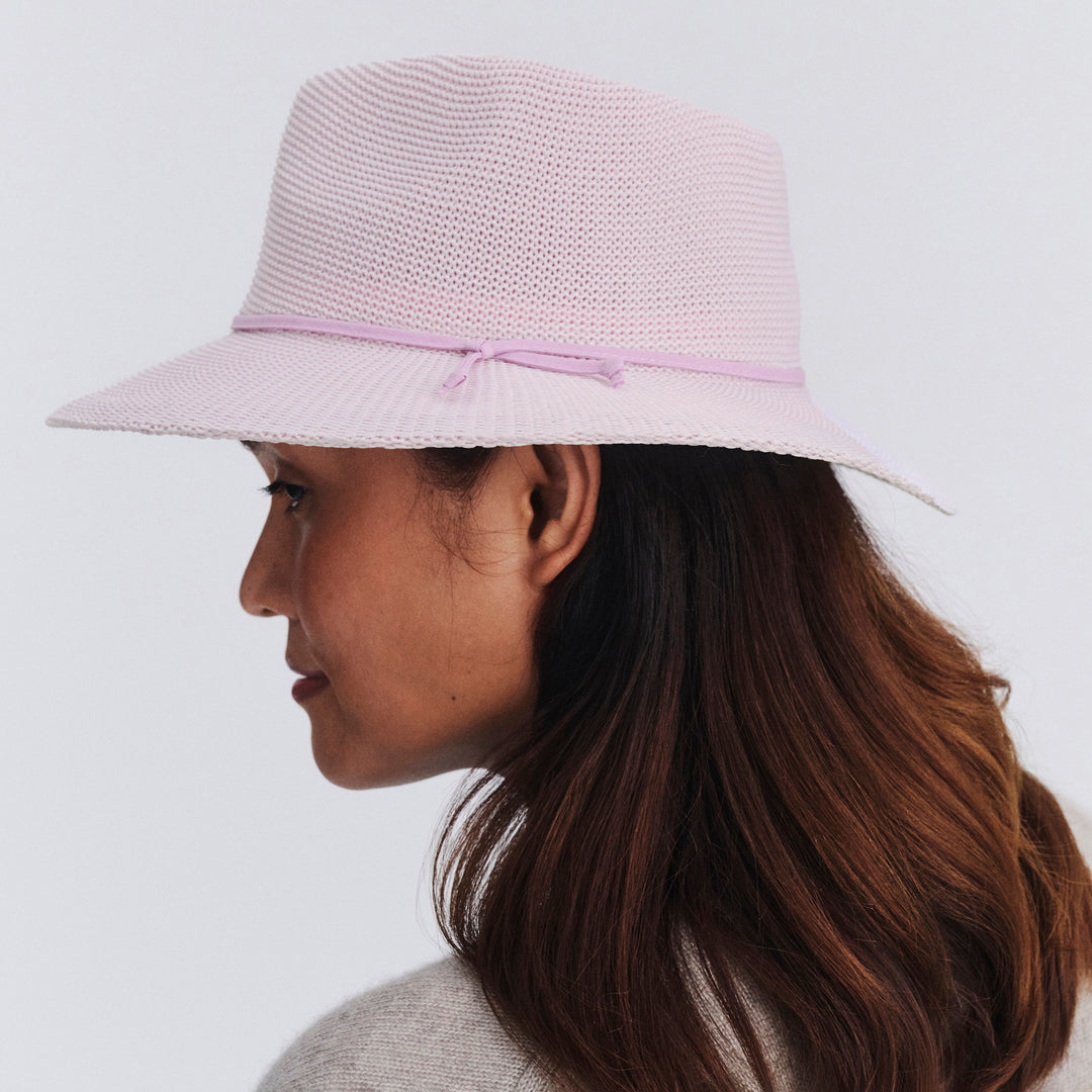 Female model wearing Jacqui Mannish Hat in Lilac colour, side profile showing brim coverage