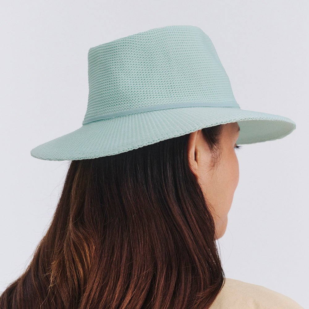 Female model wearing Jacqui Mannish Hat in mint blue colour, back view showing crown shape and fit