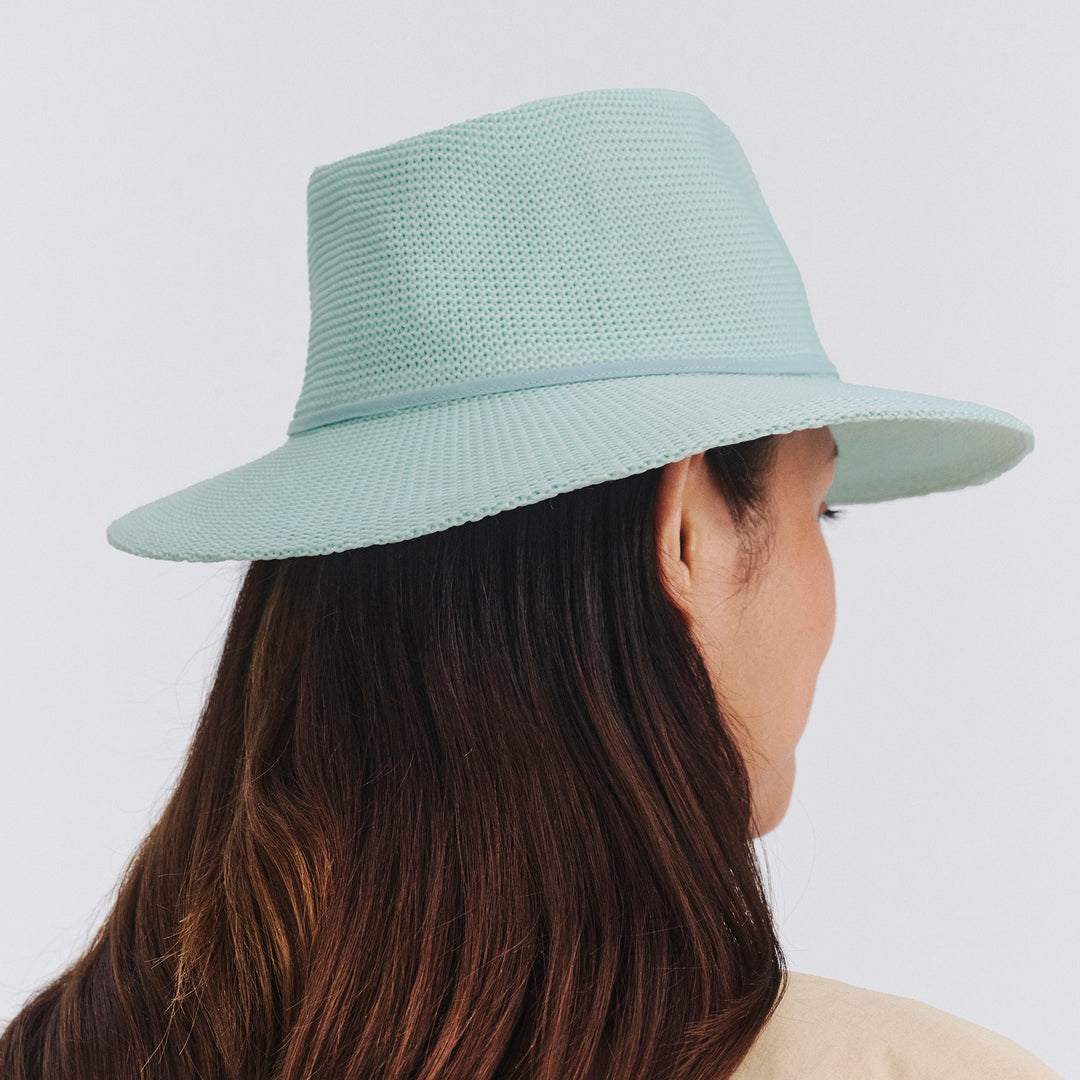Female model wearing Jacqui Mannish Hat in mint blue colour, back view showing crown shape and fit