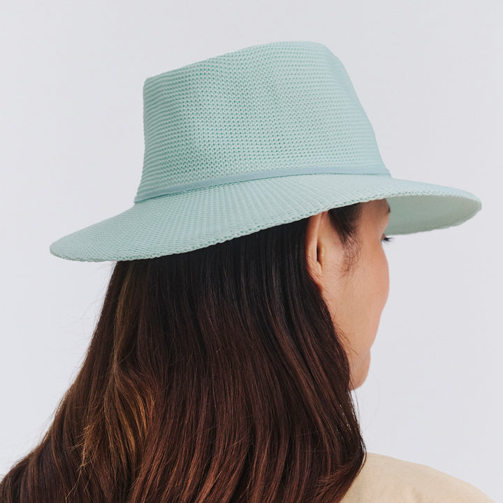 Female model wearing Jacqui Mannish Hat in mint blue colour, back view showing crown shape and fit