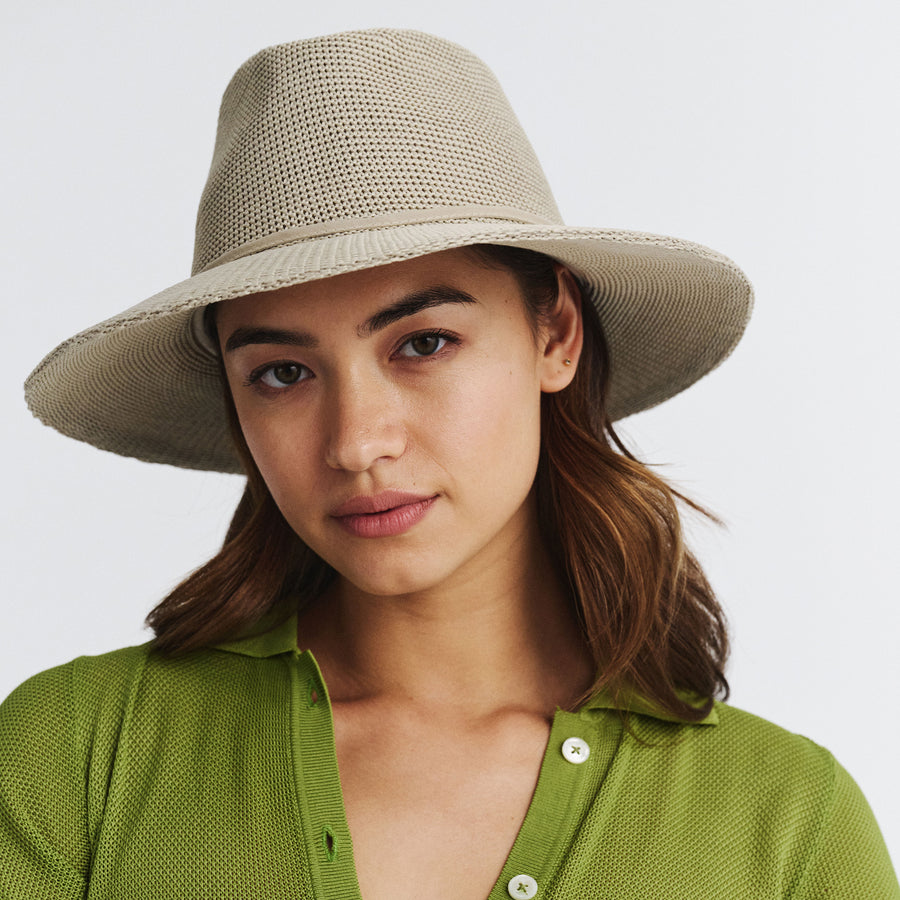 Female model wearing Jacqui Mannish Hat in stone colour, front view showcasing fit and sun-protective wide brim