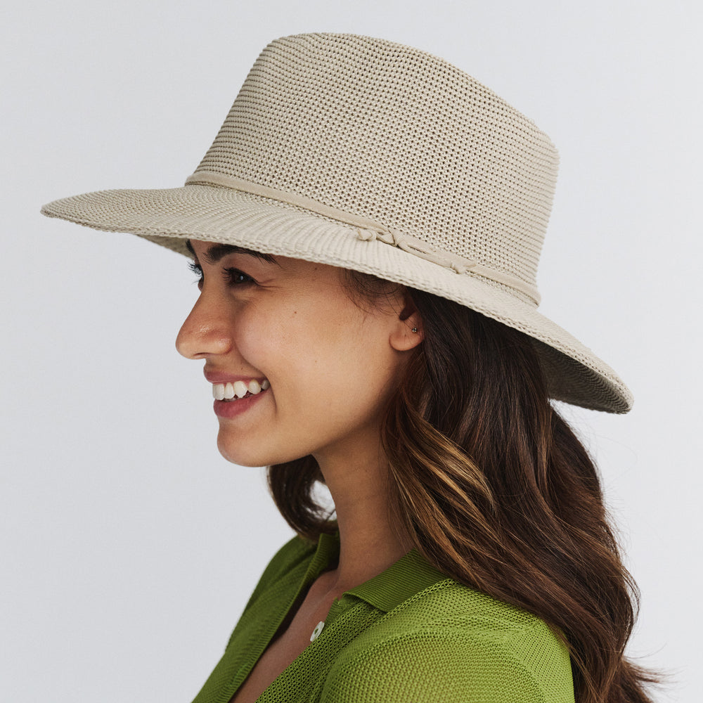 Female model wearing Jacqui Mannish Hat in stone colour, side profile showing wide brim coverage and tailored style