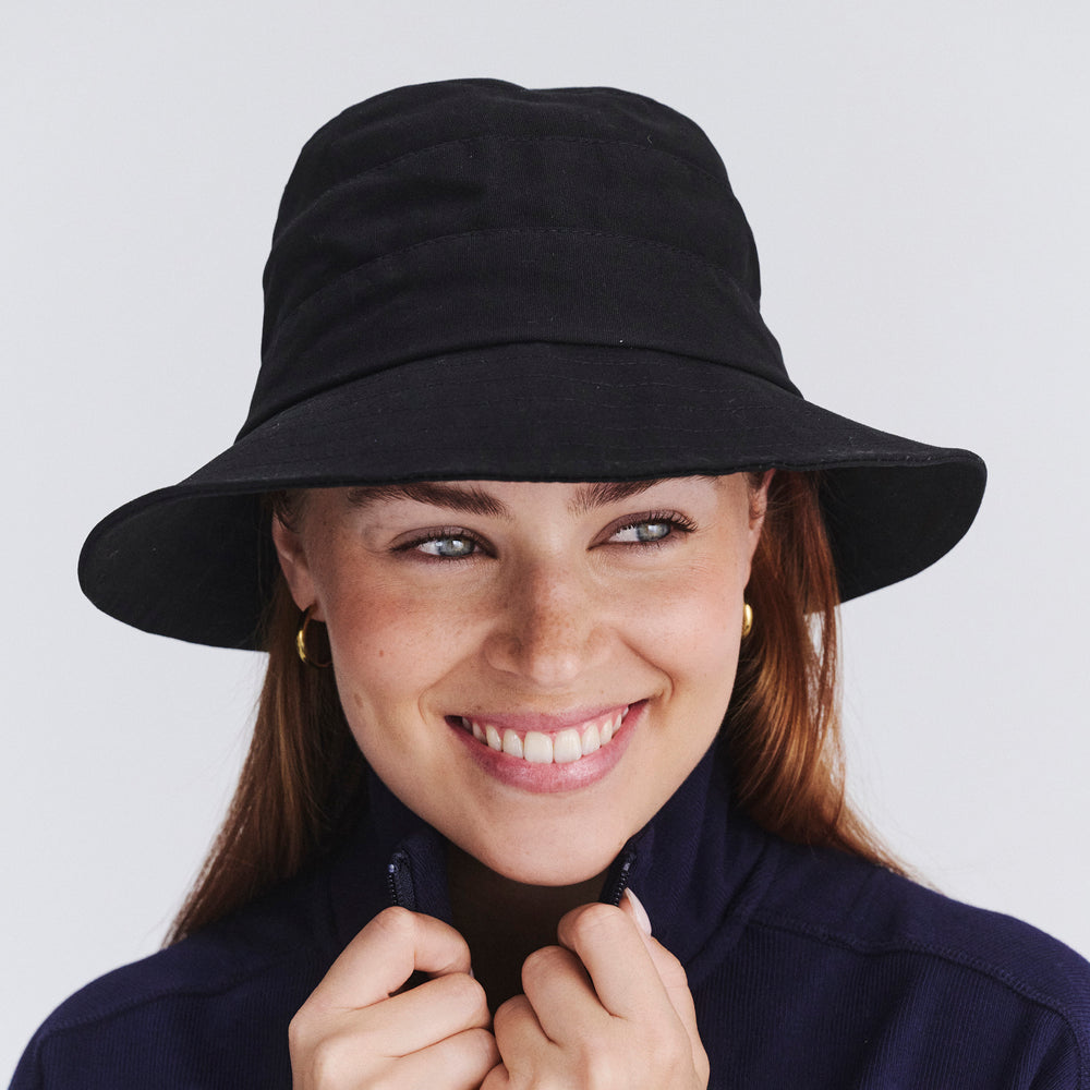 Female model wearing Golf bucket hat in Black, front‑facing view