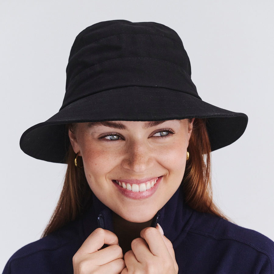 Female model wearing Golf bucket hat in Black, front‑facing view
