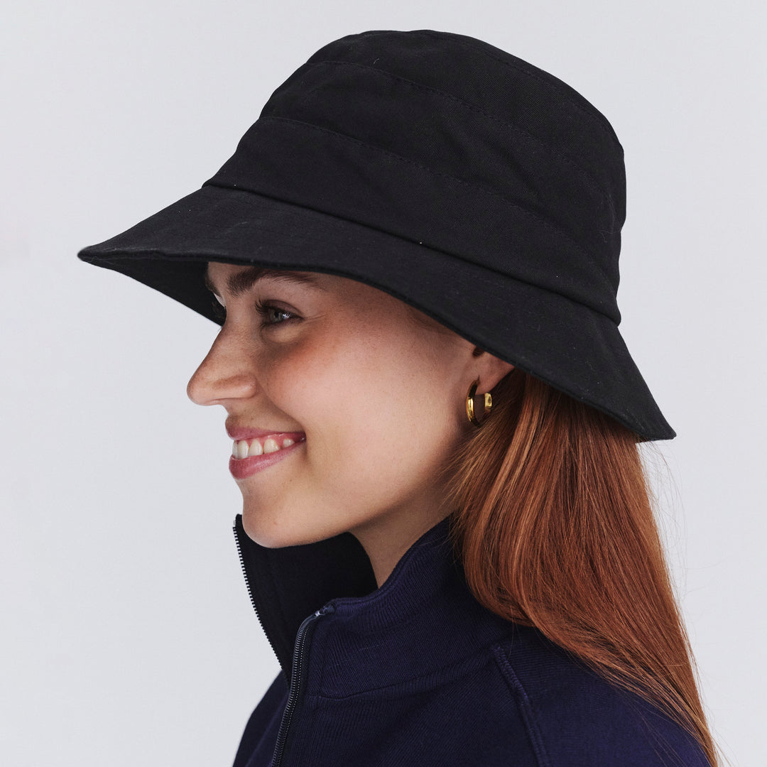 Side profile of female model wearing Golf bucket hat in Black