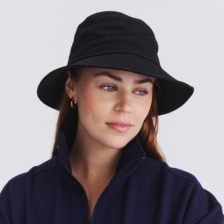 Female model wearing Golf bucket hat in Black, front‑facing view