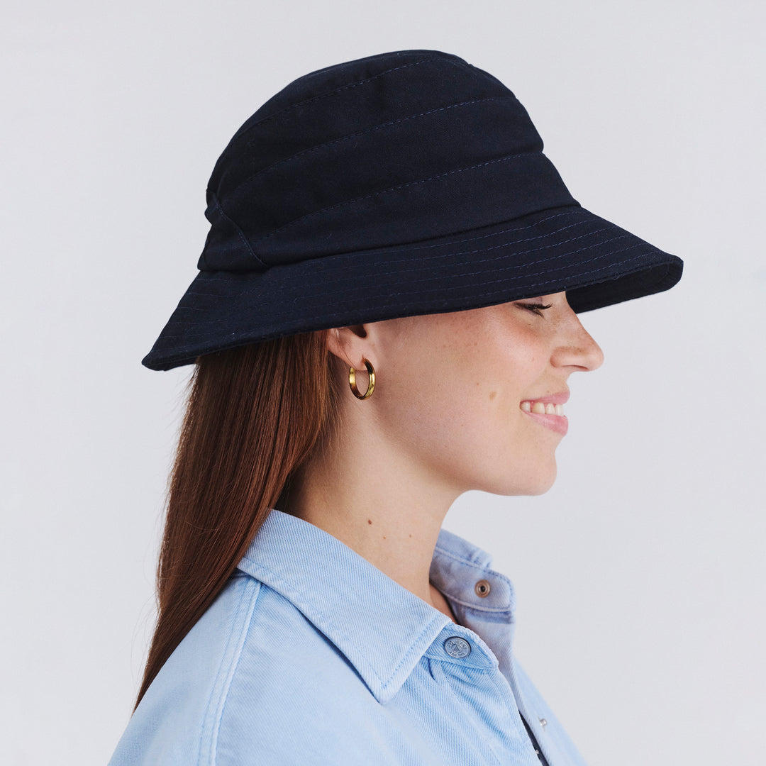 Side profile of female model wearing Golf bucket hat in Navy