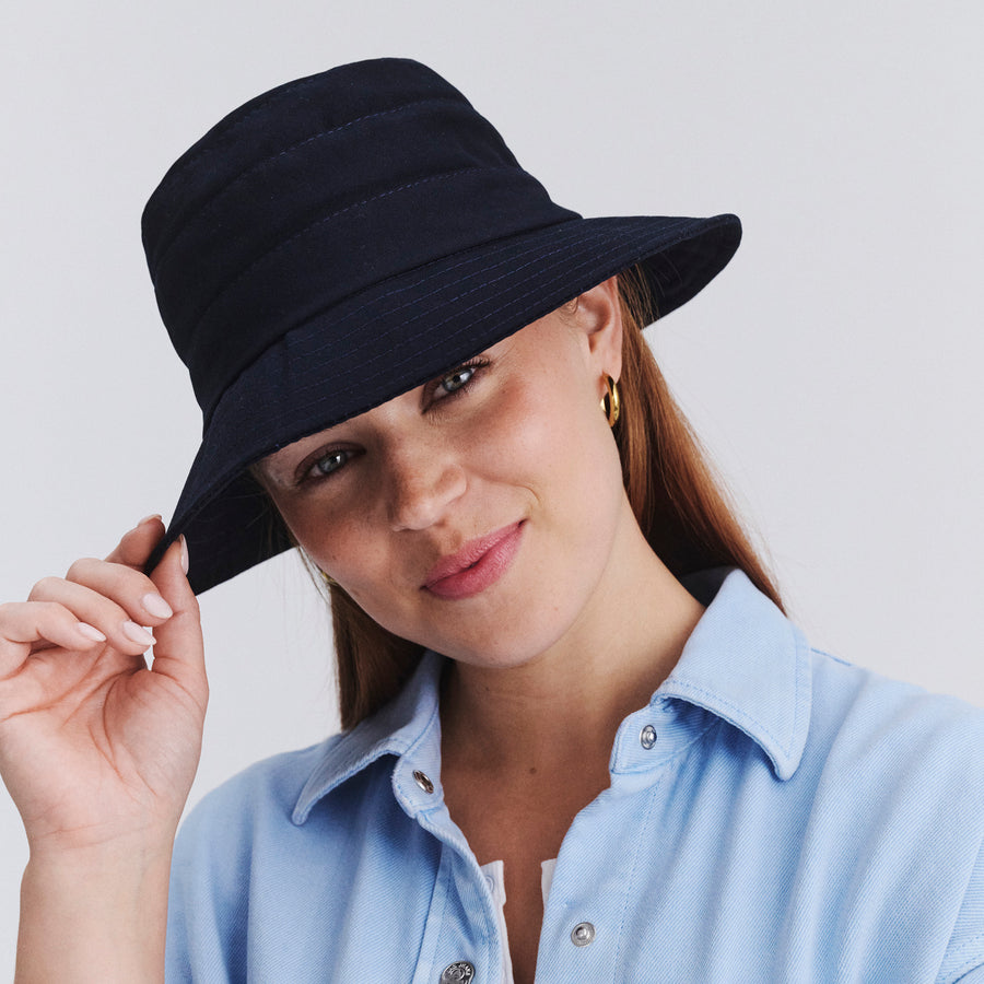 Female model wearing Golf bucket hat in Navy, front‑facing view