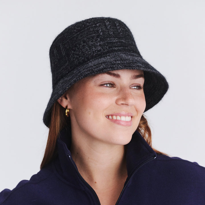 Female model wearing Jordan Bucket Hat in black soft wool, three-quarter angle highlighting fit and soft silhouette
