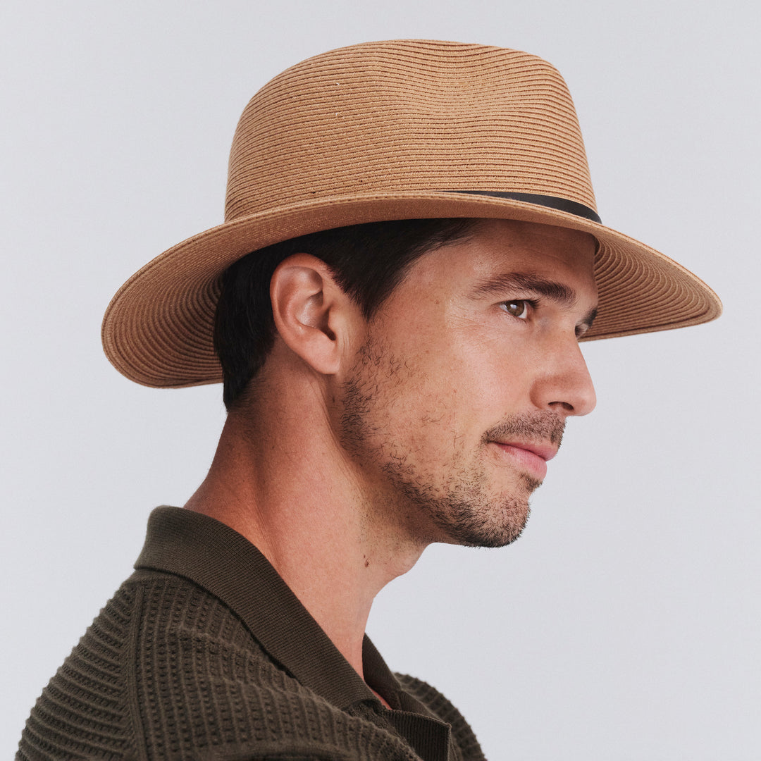 Side profile of model wearing Darby fedora hat in Sahara