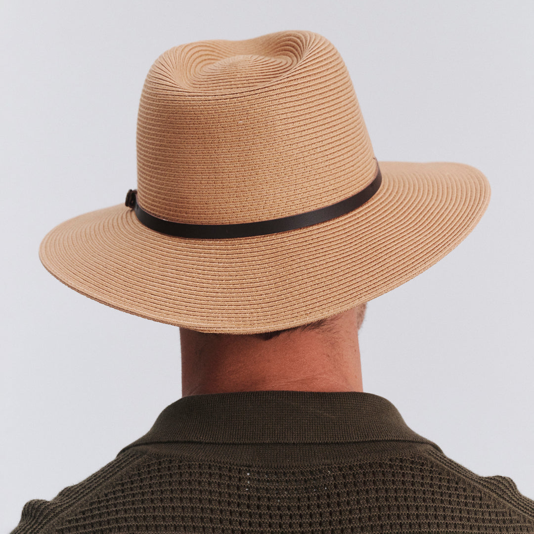 Back view of model wearing Darby fedora hat in Sahara showing brim shape and rear detailing