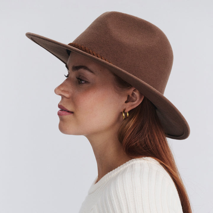 Female model wearing Blake felt fedora hat in Chocolate, three‑quarter angle