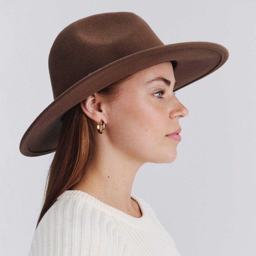 Side profile of female model wearing Blake felt fedora hat in Chocolate
