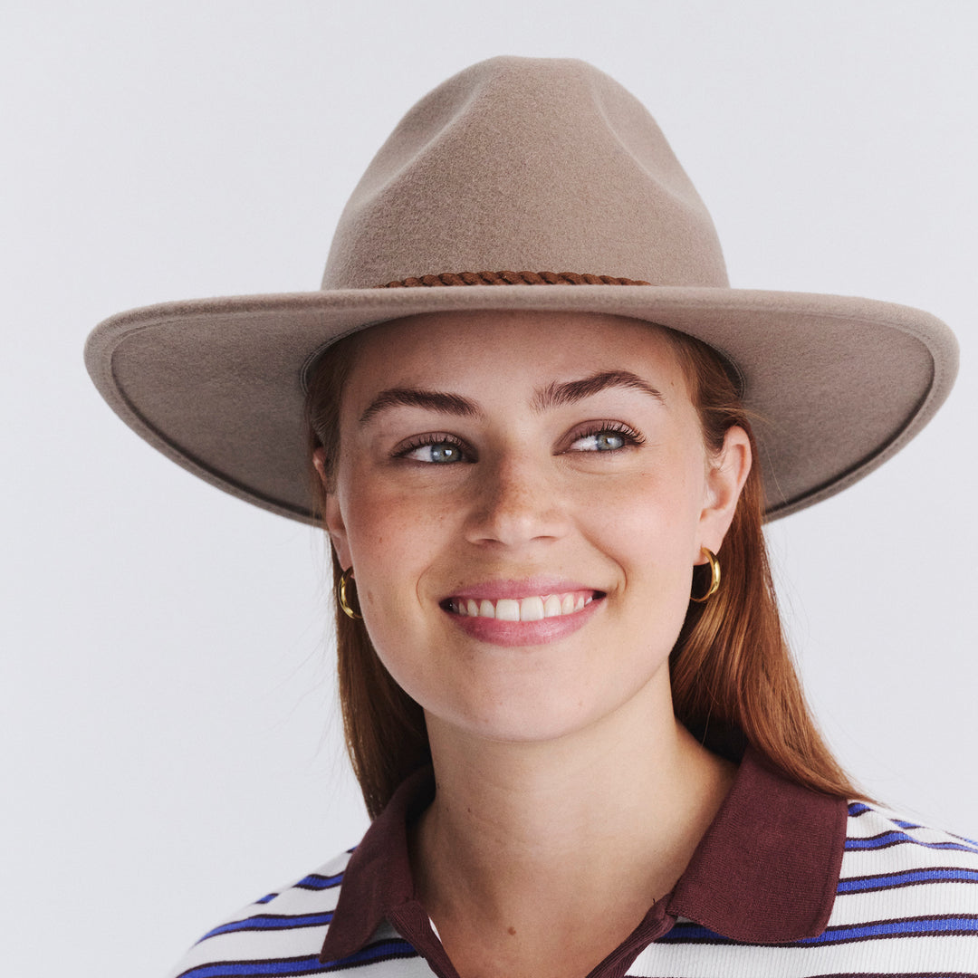Female model wearing Blake Felt Fedora in mushroom colour, front view styled with striped top