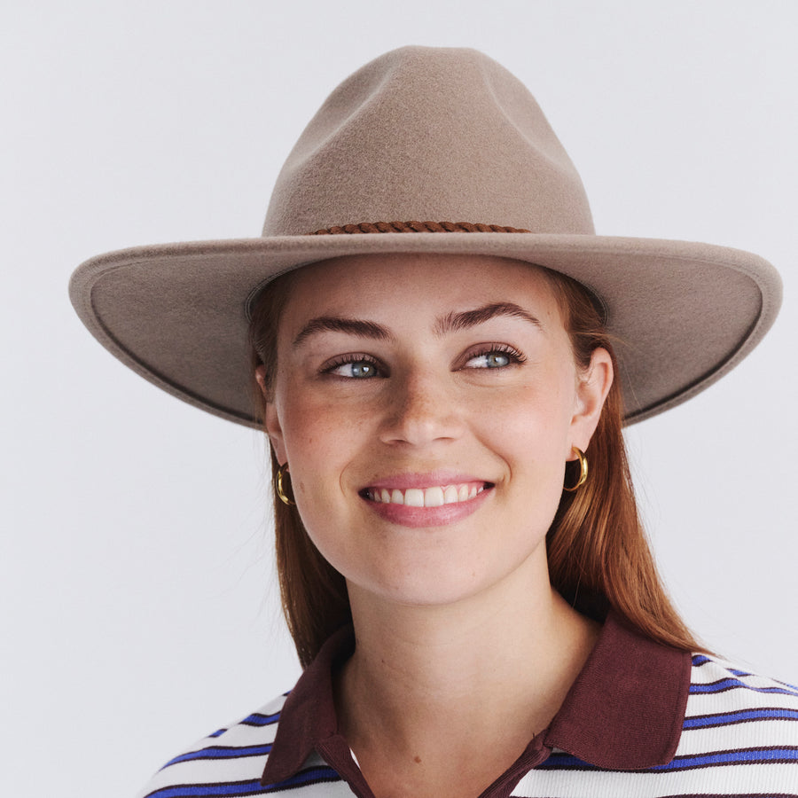 Female model wearing Blake Felt Fedora in mushroom colour, front view styled with striped top
