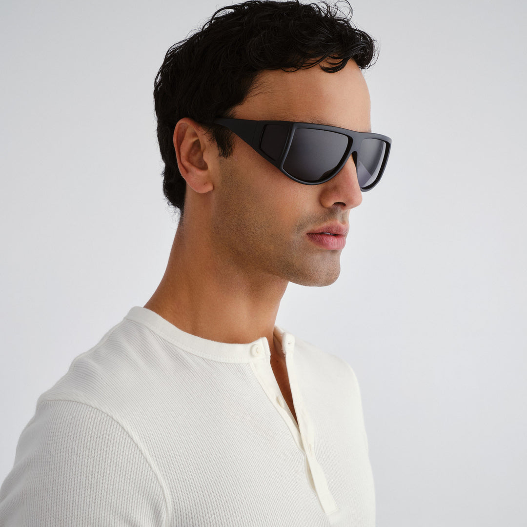 Male model wearing Nash sunglasses in matte black, side angle highlighting profile and temple detail