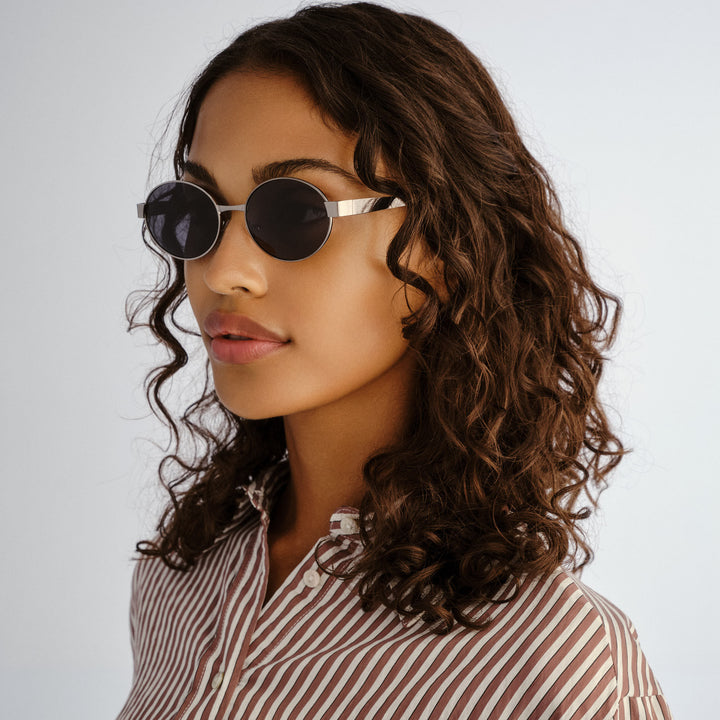 Side profile of female model wearing Norwood sunglasses in Gunmetal