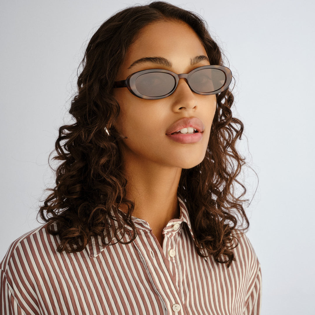 Front profile of female model wearing Northbridge sunglasses in Amber Tort
