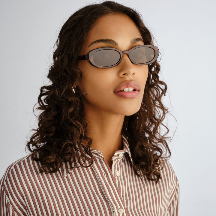 Front profile of female model wearing Northbridge sunglasses in Amber Tort