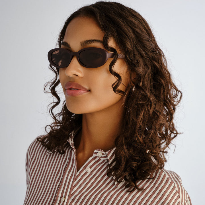 Side profile of female model wearing Northbridge sunglasses in Matte Mulberry