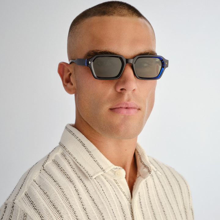 Front profile of male model wearing Mount Lawley sunglasses in Ink Blue