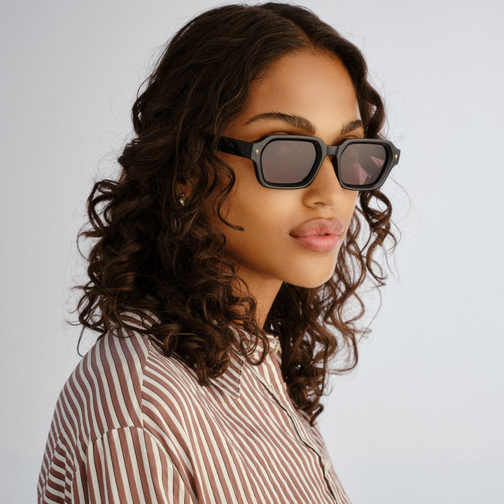 Female model wearing Mount Lawley sunglasses in Black, three‑quarter angle
