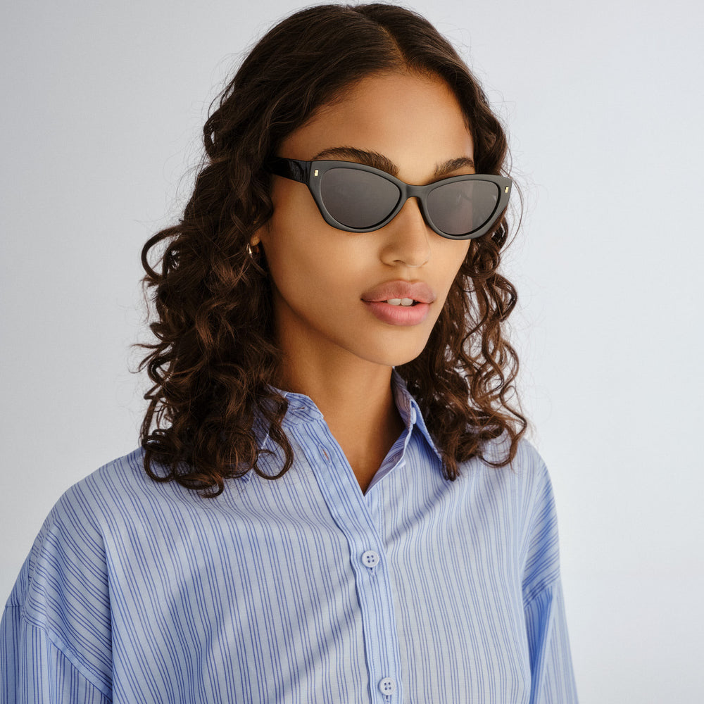 Female model wearing Swanbourne sunglasses in Black, front angle