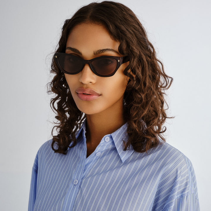 Swanbourne sunglasses on female model in Rust shown front‑on with rounded frame