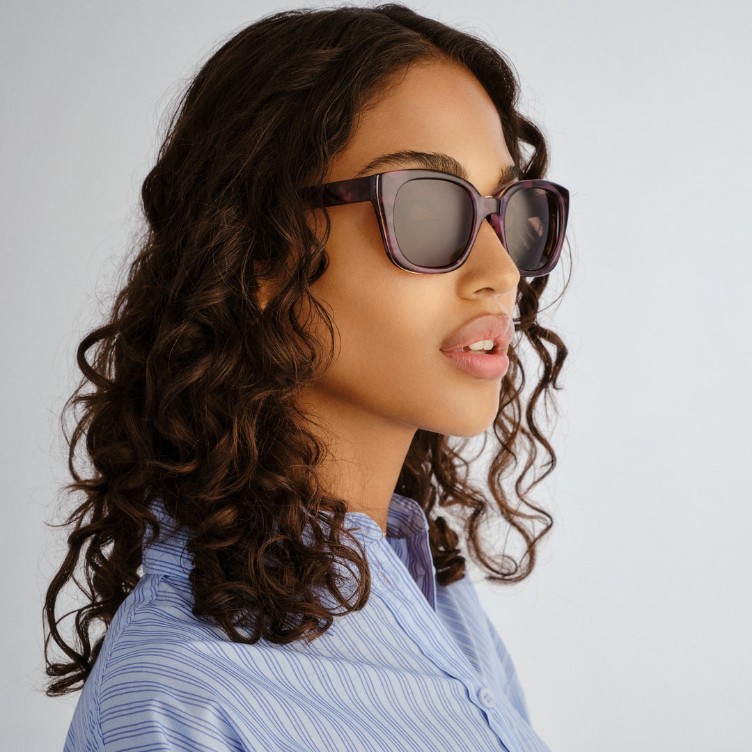 Side profile of female model wearing Teneriffe sunglasses in Purple Haze