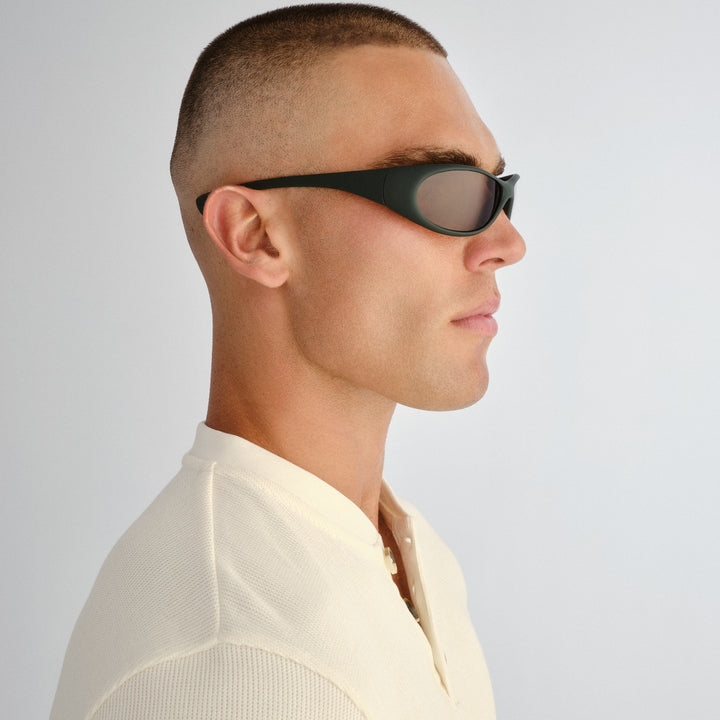 Side profile of male model wearing Logan sunglasses in Rubber Khaki