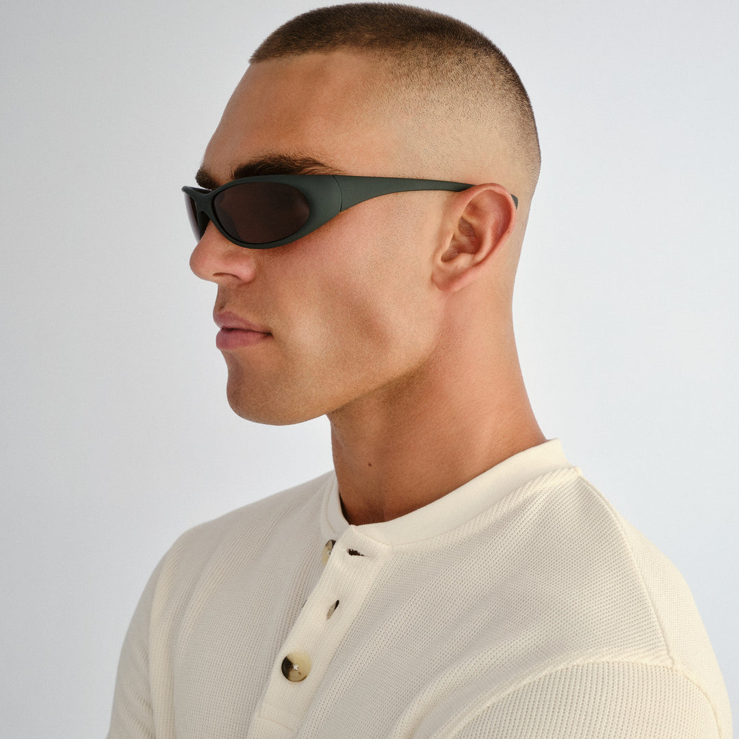 Side profile of male model wearing Logan sunglasses in Rubber Khaki