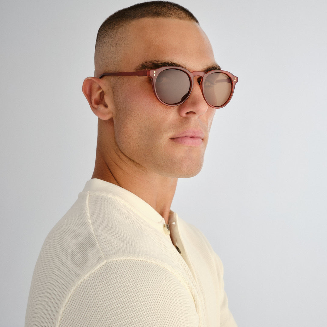 Three‑quarter angle of male model wearing Bright sunglasses in Merlot