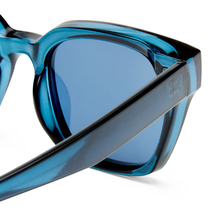 Blue sunglasses zoomed on frames on a white background